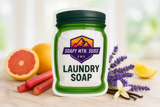 Soapy Mtn Suds Mornin Sunshine Laundry Soap pouch with grapefruit, orange, lemon, rhubarb, lavender, and vanilla flower accents on a bright background.