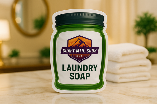 Soapy Mtn Suds Ritz-Carlton Type Laundry Soap in green mason jar bag packaging, inspired by luxury hotel signature scent, displayed on marble counter with folded white towels.