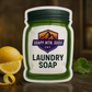 Soapy Mtn Suds Royal Creed Aventus Creed Type Laundry Soap pouch with lemon slices, green leaves, and peppercorns on a dark wood surface.