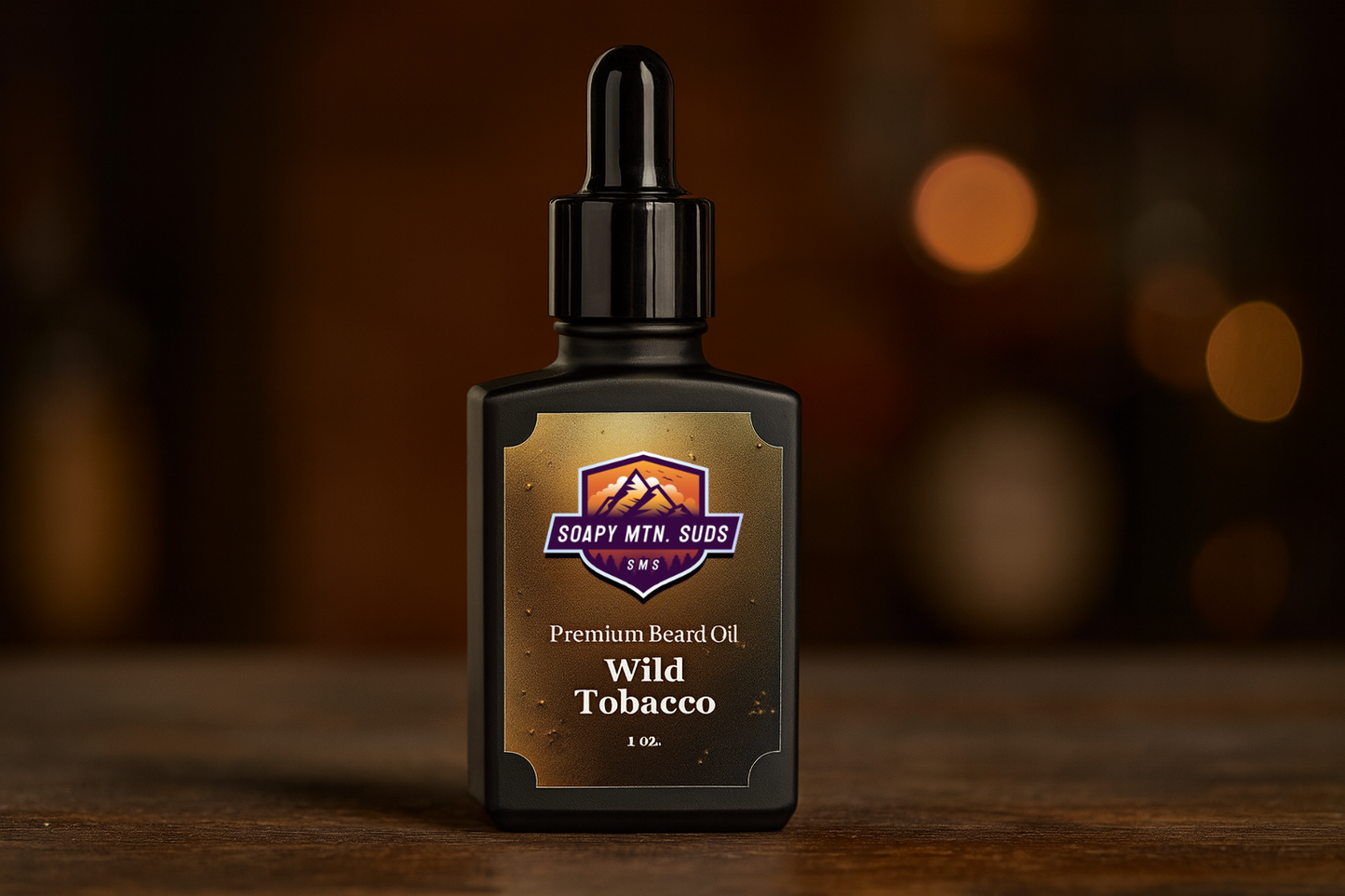 Wild Tobacco Premium Beard Oil by Soapy Mtn Suds — 1 oz black dropper bottle on rustic wood with warm amber tones, featuring bold tobacco, spice, vanilla, and wood aroma.